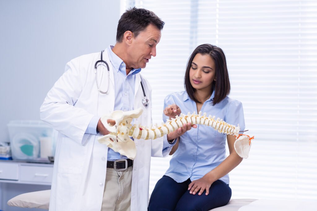physiotherapist explaining spine model to patient 2023 11 27 05 09 50 utc