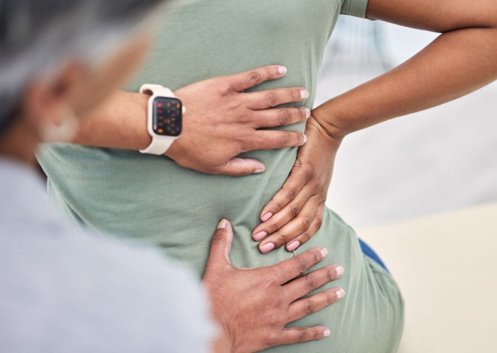 Patient at a Physiotherapy center getting checked for that tingling sensation in lower back.