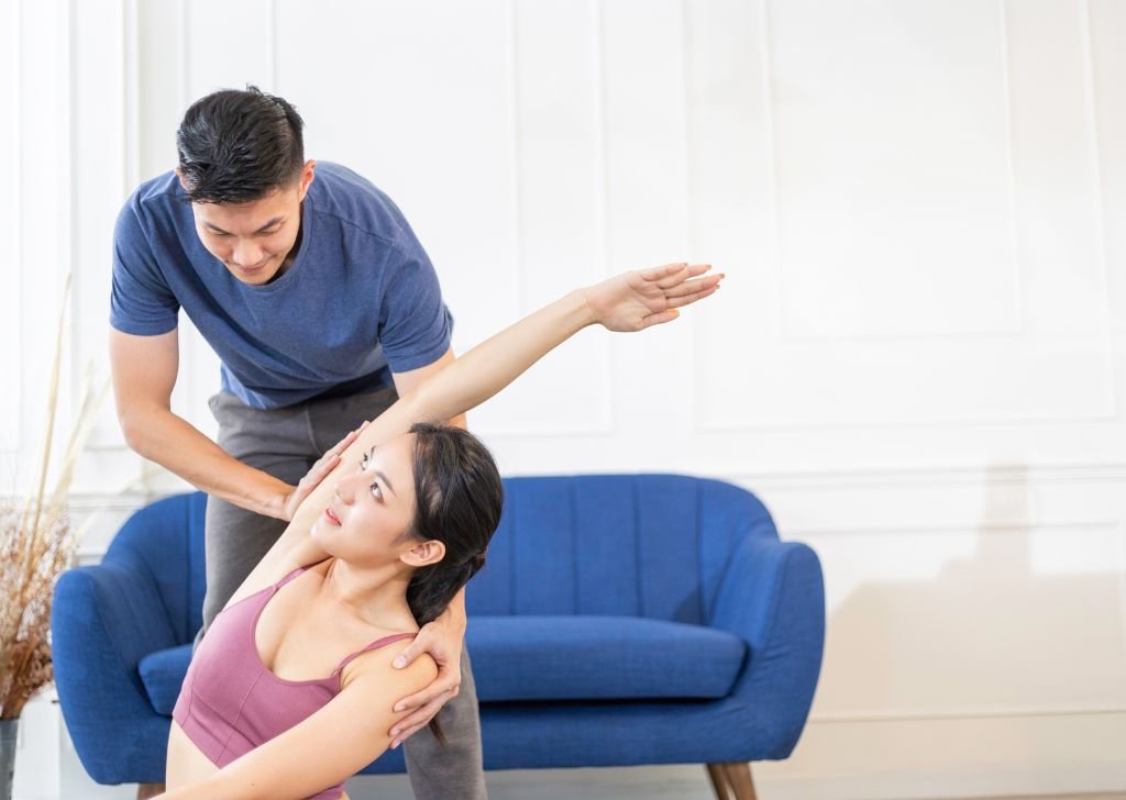 A young woman stretching during her treatment.