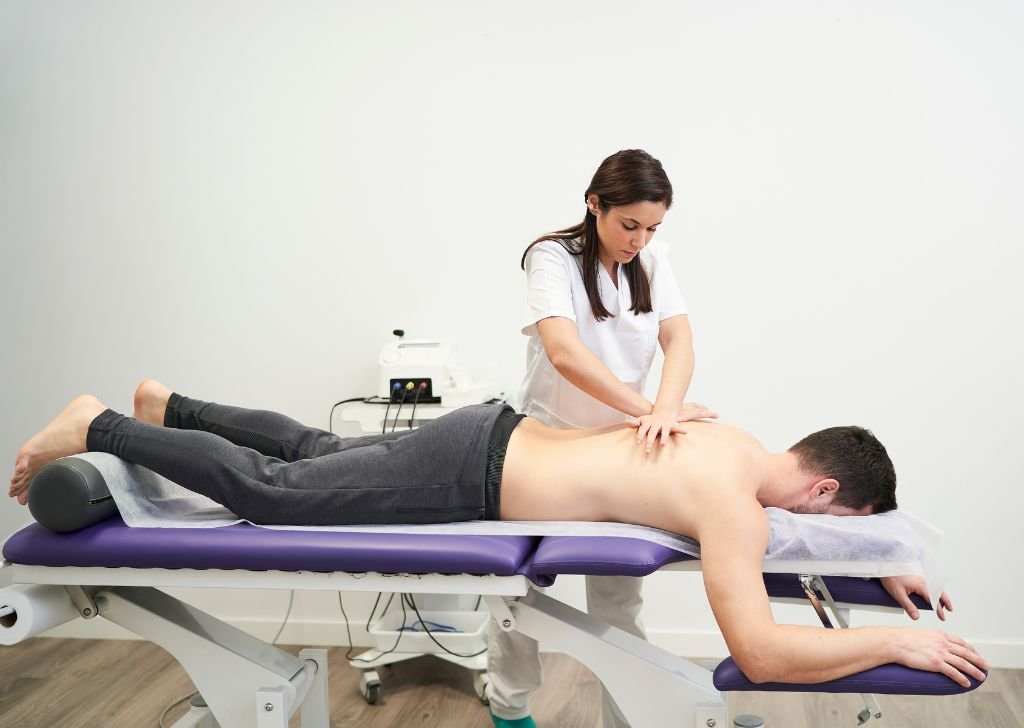 A chiropractor performing treatment for Sciatica to a patient.