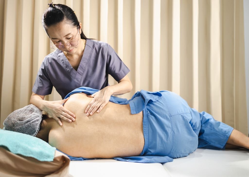 A patient getting an adjustment from a chiropractor in Petaling Jaya for back pain relief.