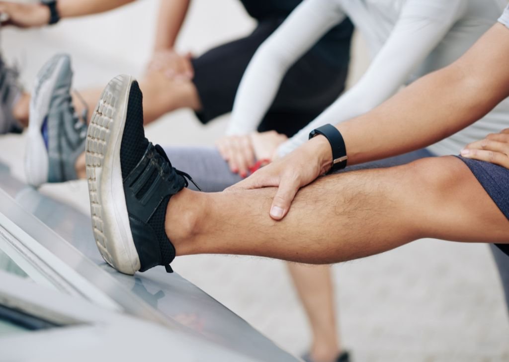 An athlete stretching their legs to prevent leg cramps in Petaling Jaya.