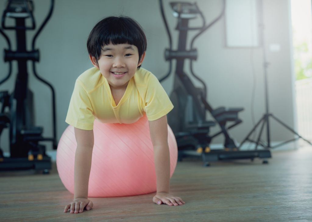 A child playing with a yoga ball at a physiotherapist.