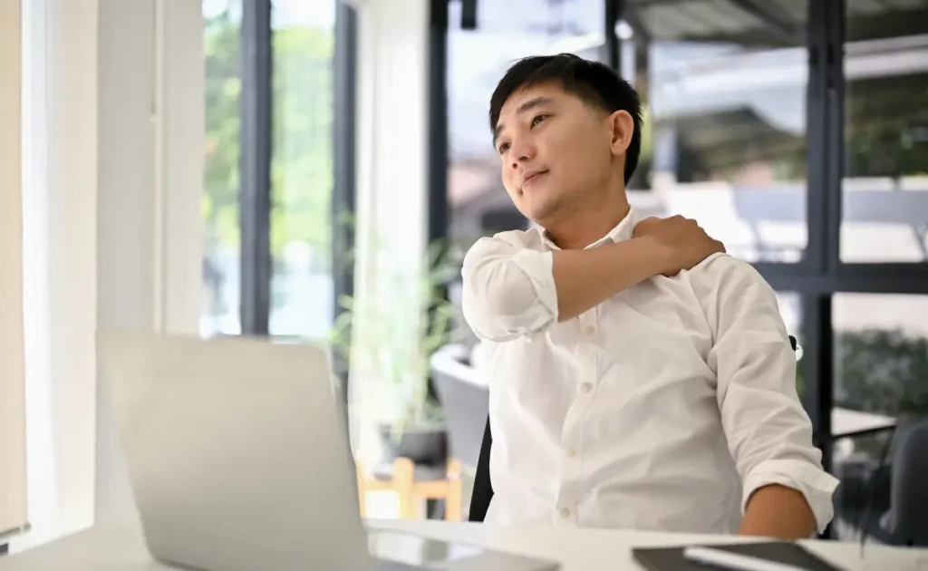 An office worker suffering from mouse shoulder pain.
