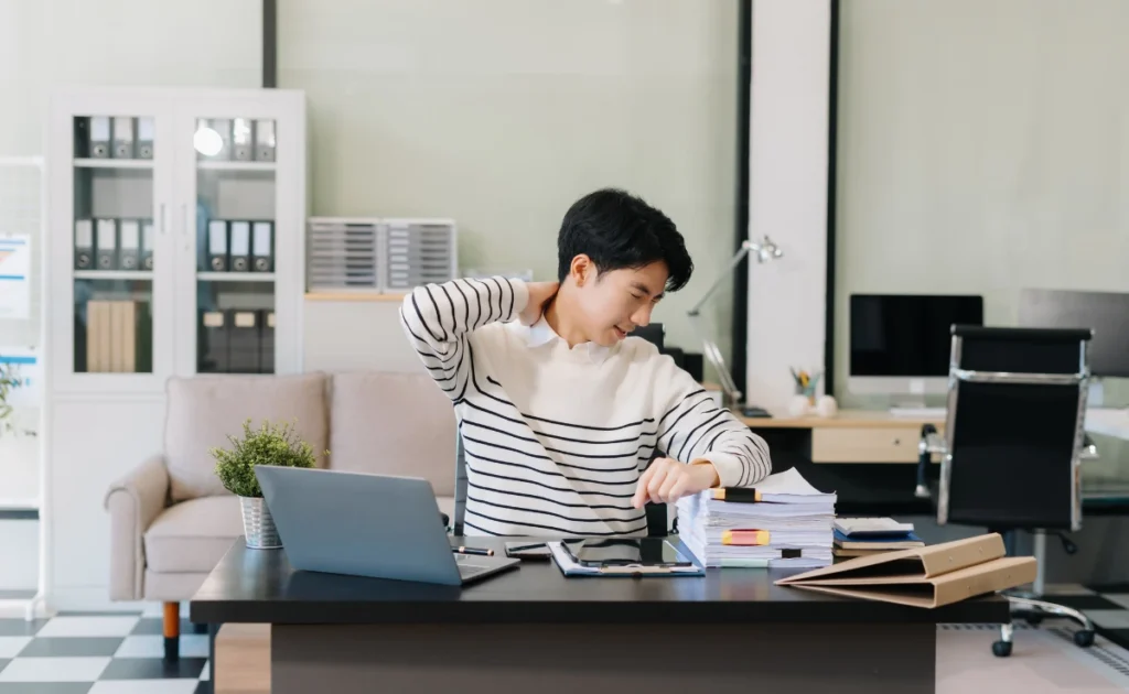 An office worker having neck pain in the workplace.